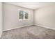 Bright bedroom with neutral carpet, a large window with blinds, and plenty of natural light at 3321 Georgian Woods Cir, Decatur, GA 30034