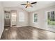 A sun-filled bedroom with hardwood floors, a ceiling fan, and easy access to the ensuite bath at 3321 Georgian Woods Cir, Decatur, GA 30034