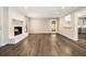 Bright open-concept living space with hardwood floors, a white fireplace, and natural light at 3321 Georgian Woods Cir, Decatur, GA 30034