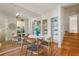 Bright dining room with wood floors, mirrored wall, and a view into the kitchen at 4254 River Green Dr # 613, Atlanta, GA 30327