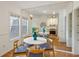 Bright dining room with wood floors, mirrored wall, and a view into the kitchen at 4254 River Green Dr # 613, Atlanta, GA 30327