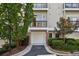 Charming condo exterior features a private balcony, one-car garage, and lush landscaping at 4254 River Green Dr # 613, Atlanta, GA 30327