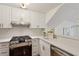 Updated kitchen with white cabinetry, stainless steel oven and range, and quartz countertops at 4254 River Green Dr # 613, Atlanta, GA 30327