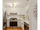 Bright kitchen features white cabinets, stainless steel appliances, and a modern gold faucet at 4254 River Green Dr # 613, Atlanta, GA 30327