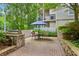 Outdoor patio with stone barbecue grill and comfortable seating area at 4254 River Green Dr # 613, Atlanta, GA 30327