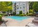 Community pool surrounded by lush landscaping and comfortable lounge chairs at 4254 River Green Dr # 613, Atlanta, GA 30327