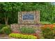 The River West Condominium monument sign on stone base amid manicured flowerbed at 4254 River Green Dr # 613, Atlanta, GA 30327