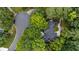 Aerial view of a luxury home nestled among mature trees and lush landscaping in a quiet cul-de-sac at 625 Wynfield Ct, Roswell, GA 30076