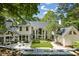 Expansive backyard featuring a stone patio, water feature, manicured landscaping, and an abundance of natural light at 625 Wynfield Ct, Roswell, GA 30076