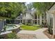 Relaxing backyard oasis with a spa, lounge area, lush landscaping, and a stone-paved patio at 625 Wynfield Ct, Roswell, GA 30076