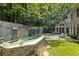 Serene backyard featuring a waterfall, patio seating, and beautifully landscaped surroundings at 625 Wynfield Ct, Roswell, GA 30076