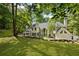Beautiful backyard featuring a lush lawn and mature trees providing privacy and shade at 625 Wynfield Ct, Roswell, GA 30076