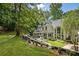 Expansive backyard with lush greenery, a waterfall feature, and a charming outdoor patio at 625 Wynfield Ct, Roswell, GA 30076