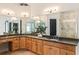 Bathroom vanity with double sinks, granite countertop, wood cabinets, and large mirrors at 625 Wynfield Ct, Roswell, GA 30076