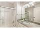 Bathroom featuring a tub-shower with glass enclosure and vanity with granite countertop at 625 Wynfield Ct, Roswell, GA 30076