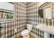 Stylish powder room with designer wallpaper, floating vanity, and elegant mirror creates a modern look at 625 Wynfield Ct, Roswell, GA 30076