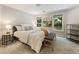 Bedroom featuring a comfortable bed, two windows overlooking the backyard at 625 Wynfield Ct, Roswell, GA 30076