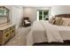 Cozy bedroom featuring a comfortable bed, dresser, and a large window overlooking the backyard at 625 Wynfield Ct, Roswell, GA 30076