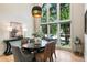 Dining area with large windows, contemporary lighting, and table set for an elegant meal at 625 Wynfield Ct, Roswell, GA 30076