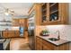Modern eat-in kitchen featuring stainless steel appliances, wooden cabinets, and wine storage at 625 Wynfield Ct, Roswell, GA 30076