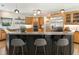 A modern kitchen with stainless steel appliances, wooden cabinets, and a breakfast bar with seating for three at 625 Wynfield Ct, Roswell, GA 30076