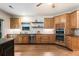 Spacious eat-in kitchen featuring stainless steel appliances, custom cabinets, stone countertops, and wooden floors at 625 Wynfield Ct, Roswell, GA 30076