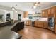 Bright kitchen with wooden floors, stainless appliances, stone countertops, and backsplash at 625 Wynfield Ct, Roswell, GA 30076