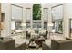 Bright living room featuring large windows, hardwood floors, and stylish furniture at 625 Wynfield Ct, Roswell, GA 30076