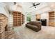 Spacious living room with stone fireplace, and custom built-in shelving at 625 Wynfield Ct, Roswell, GA 30076