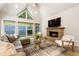 Cozy living room with a stone fireplace, comfortable seating, and large windows for natural light at 625 Wynfield Ct, Roswell, GA 30076