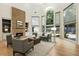 Bright living room features a stone fireplace, built-in bookshelves, and large windows offering great views at 625 Wynfield Ct, Roswell, GA 30076