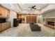 Open living room with a stone fireplace, built in cabinets, and ceiling fan at 625 Wynfield Ct, Roswell, GA 30076
