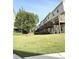Lush backyard with green grass leading to the rear of a multi-unit townhome at 6817 Blackstone Pl # 16, Mableton, GA 30126