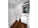 Well-lit bathroom with a tub/shower combo, white vanity, and hardwood floors at 6817 Blackstone Pl # 16, Mableton, GA 30126