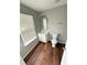 Well-lit bathroom with hardwood floors, vanity, and a toilet at 6817 Blackstone Pl # 16, Mableton, GA 30126