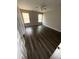 Spacious bedroom with a ceiling fan, hardwood floors, and natural light from two windows at 6817 Blackstone Pl # 16, Mableton, GA 30126