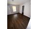 Spacious bedroom featuring stylish flooring, a bright window, and a connecting bathroom at 6817 Blackstone Pl # 16, Mableton, GA 30126