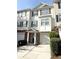 Charming townhouse featuring a brick facade, attached garage, and a welcoming entrance at 6817 Blackstone Pl # 16, Mableton, GA 30126
