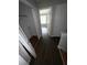 Upstairs hallway with dark wood floors and open doorways at 6817 Blackstone Pl # 16, Mableton, GA 30126