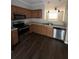 Kitchen view showcasing stainless steel appliances, and wood cabinets with open access to dining area at 6817 Blackstone Pl # 16, Mableton, GA 30126