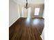 Spacious living room with dark wood flooring, a modern light fixture, and large glass sliding doors at 6817 Blackstone Pl # 16, Mableton, GA 30126