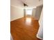 Open living room with hardwood floors, neutral paint, large windows, and ceiling fan at 6817 Blackstone Pl # 16, Mableton, GA 30126