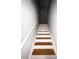 Staircase with hardwood steps, white risers, and a white handrail, leading upstairs at 6817 Blackstone Pl # 16, Mableton, GA 30126