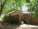 View of a backyard with a covered porch and mature trees, offering a private setting at 2448 Sherbrooke Ne Ct, Atlanta, GA 30345