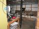 Unfinished basement with exposed ceiling, shelves, work bench and unfinished walls at 2448 Sherbrooke Ne Ct, Atlanta, GA 30345