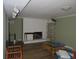 Open basement space features a fireplace, track lights and exposed ceiling at 2448 Sherbrooke Ne Ct, Atlanta, GA 30345