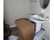 Small bathroom with a pedestal sink and white toilet at 2448 Sherbrooke Ne Ct, Atlanta, GA 30345