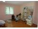 Cozy bedroom with hardwood floors, a window with blinds, and ample space for furniture at 2448 Sherbrooke Ne Ct, Atlanta, GA 30345