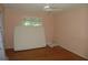 Simple bedroom featuring hardwood floors, a window, ceiling fan, and neutral-colored walls at 2448 Sherbrooke Ne Ct, Atlanta, GA 30345