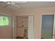 Bedroom with hardwood floors, a window with green views, and a closet with shelving at 2448 Sherbrooke Ne Ct, Atlanta, GA 30345